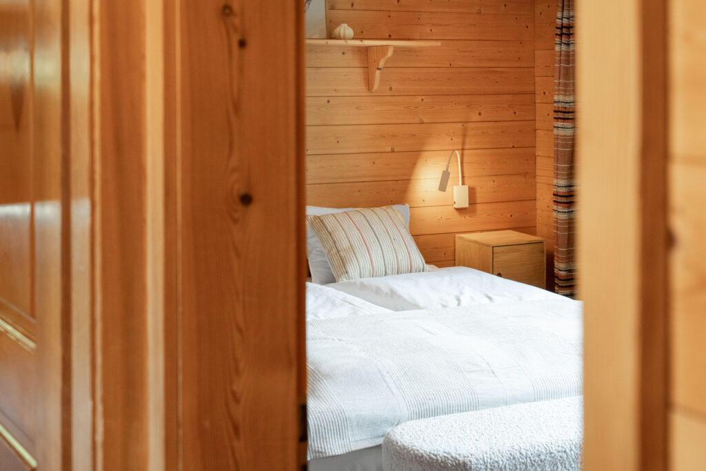 Cozy bedroom with nightstand lights at Chalet Dahai Kandersteg