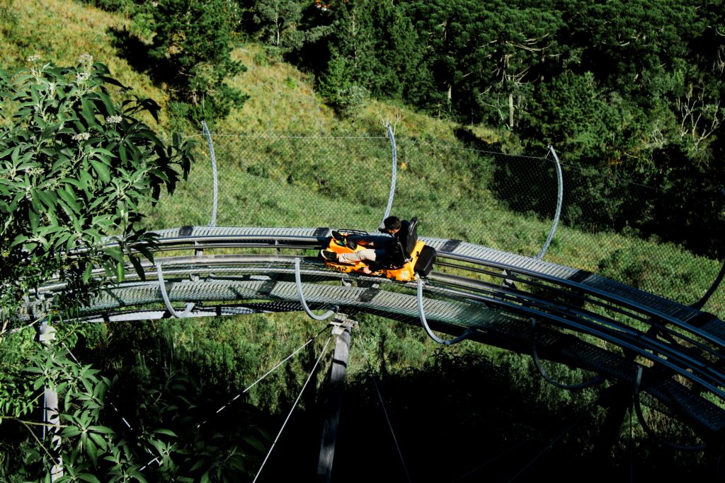 Thrilling mountain coaster ride through lush landscapes in Campos do Jordão, Brazil.
