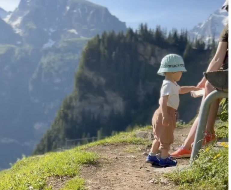Toddler having a snack up on the Swiss mountains in Kandersteg