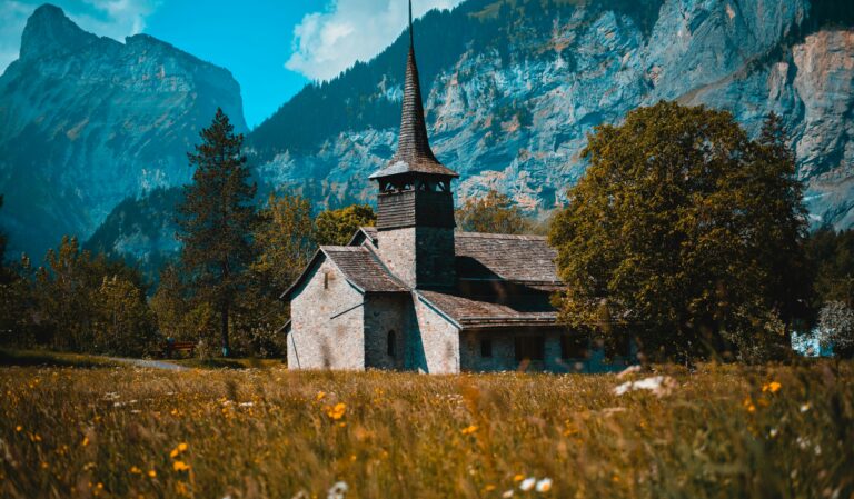 Autumn image of church in Kandersteg with mountain backdrop