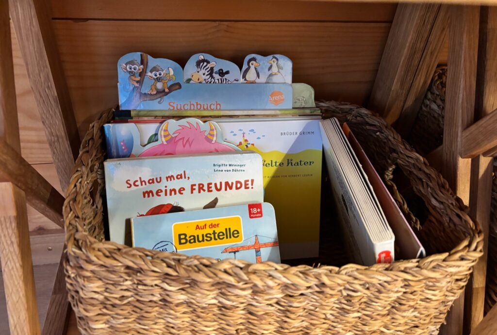 Young toddlers books and baby books in wickers basket